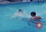 Image of men splashing swimming pool Las Vegas Nevada USA, 1967, second 9 stock footage video 65675079700