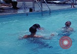Image of men splashing swimming pool Las Vegas Nevada USA, 1967, second 14 stock footage video 65675079700