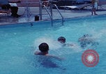 Image of men splashing swimming pool Las Vegas Nevada USA, 1967, second 15 stock footage video 65675079700