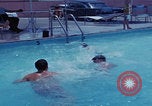 Image of men splashing swimming pool Las Vegas Nevada USA, 1967, second 17 stock footage video 65675079700