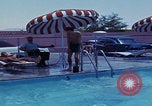 Image of men splashing swimming pool Las Vegas Nevada USA, 1967, second 23 stock footage video 65675079700