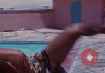 Image of men splashing swimming pool Las Vegas Nevada USA, 1967, second 31 stock footage video 65675079700