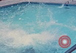 Image of men splashing swimming pool Las Vegas Nevada USA, 1967, second 32 stock footage video 65675079700
