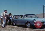 Image of flat tire desert driving United States USA, 1967, second 19 stock footage video 65675079702