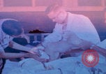 Image of US Army doctors treating leg Vietnam, 1967, second 5 stock footage video 65675080307