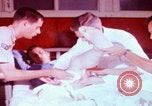 Image of US Army doctors treating leg Vietnam, 1967, second 8 stock footage video 65675080307