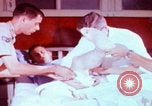 Image of US Army doctors treating leg Vietnam, 1967, second 9 stock footage video 65675080307