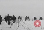 Image of 101st Airborne marching in snow Bastogne Belgium, 1945, second 9 stock footage video 65675080486