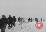 Image of 101st Airborne marching in snow Bastogne Belgium, 1945, second 15 stock footage video 65675080486