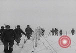 Image of 101st Airborne marching in snow Bastogne Belgium, 1945, second 18 stock footage video 65675080486