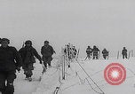 Image of 101st Airborne marching in snow Bastogne Belgium, 1945, second 19 stock footage video 65675080486