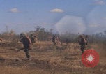 Image of US soldiers running Vietnam, 1968, second 14 stock footage video 65675080525