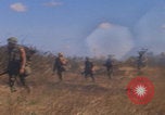 Image of US soldiers running Vietnam, 1968, second 18 stock footage video 65675080525