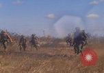 Image of US soldiers running Vietnam, 1968, second 20 stock footage video 65675080525