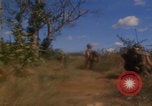 Image of US soldiers running Vietnam, 1968, second 33 stock footage video 65675080525