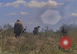 Image of US soldiers running Vietnam, 1968, second 50 stock footage video 65675080525