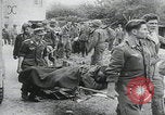 Image of German prisoners carry wounded Saint Mere Eglise France, 1944, second 4 stock footage video 65675080724
