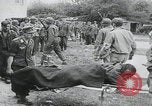 Image of German prisoners carry wounded Saint Mere Eglise France, 1944, second 5 stock footage video 65675080724