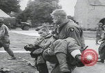 Image of German prisoners carry wounded Saint Mere Eglise France, 1944, second 25 stock footage video 65675080724