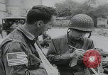 Image of German prisoners carry wounded Saint Mere Eglise France, 1944, second 36 stock footage video 65675080724