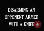 Image of practicing disarming opponent with knife United States USA, 1938, second 5 stock footage video 65675080899