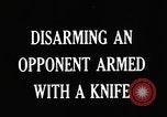 Image of practicing disarming opponent with knife United States USA, 1938, second 7 stock footage video 65675080899