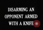 Image of practicing disarming opponent with knife United States USA, 1938, second 8 stock footage video 65675080899