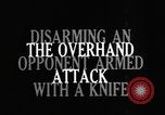 Image of practicing disarming opponent with knife United States USA, 1938, second 10 stock footage video 65675080899